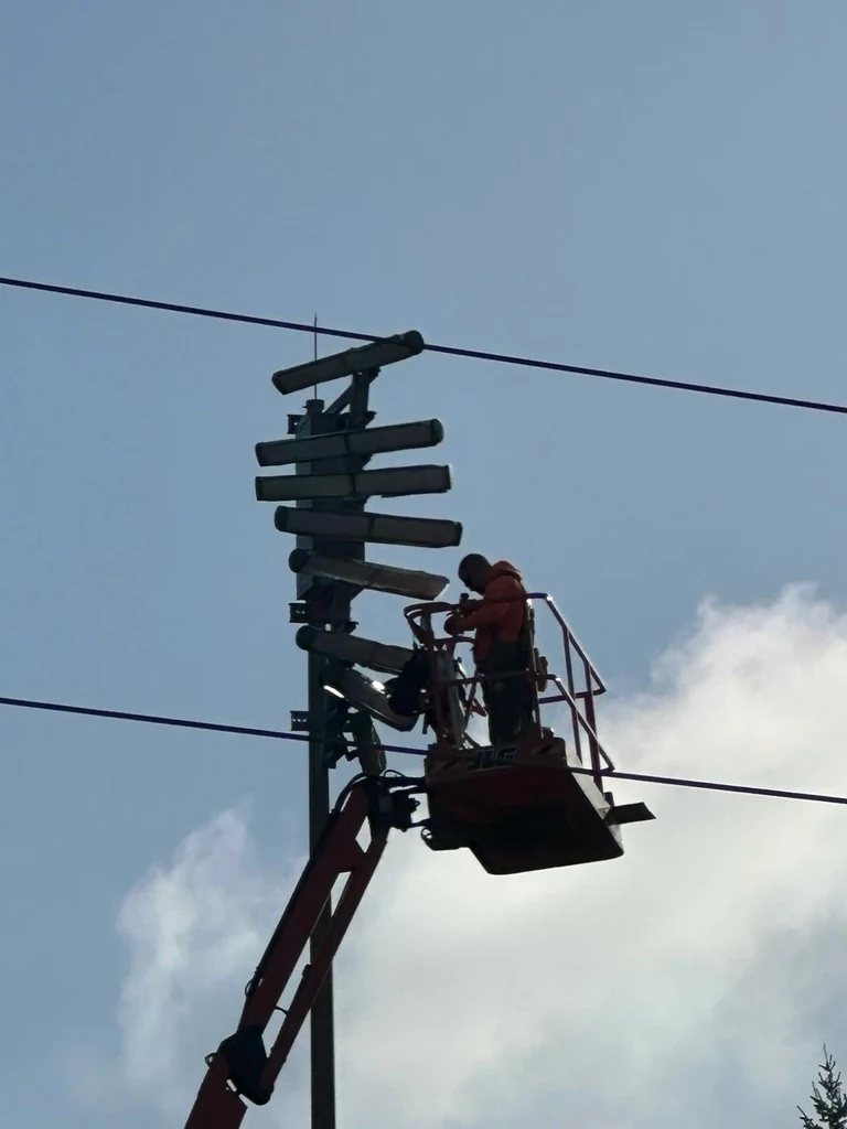 A Pro Tech Power electrician working from a bucket lift on a signal mast